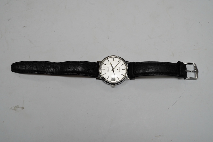 A gentleman's stainless steel Longines Conquest Automatic wrist watch, on an associated leather strap, case diameter 35mm. Condition - poor to fair